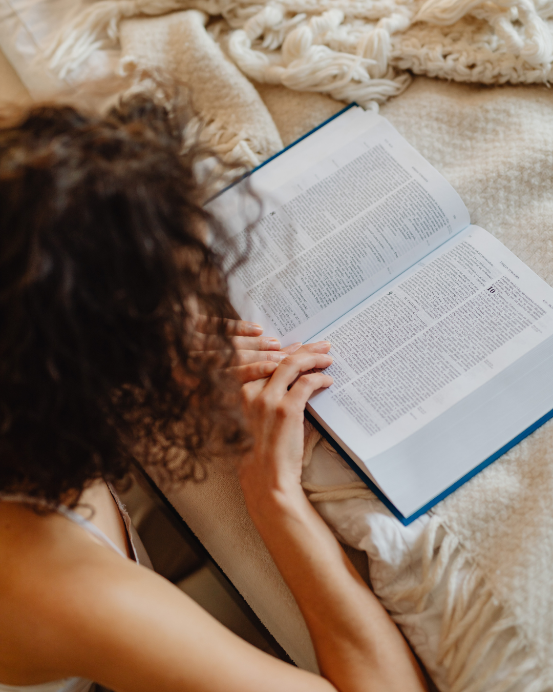 A woman reading her bible for clarity and embrace worth