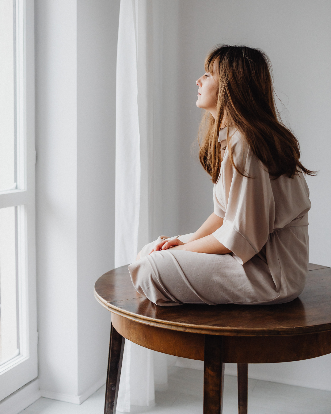 Woman sitting by the window
